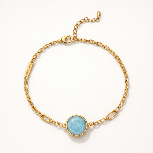Cora aquamarine bracelet — gold-chain NFC smart jewelry with a pale blue aquamarine stone for calm and clear communication